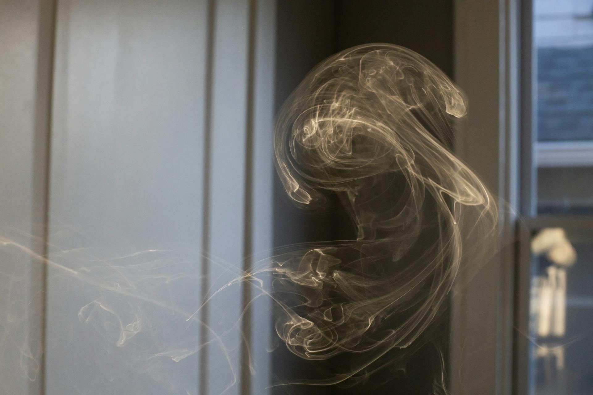 Cigarette smoke in motion in room