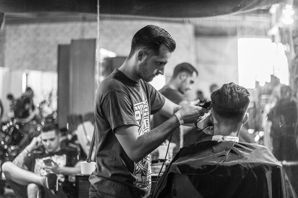 Inside the SharpLine barbershop, barbers at work