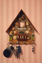 Keys hanging on wooden decorative vintage house on wall