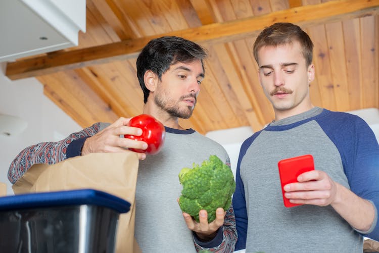 A Couple Checking Their Groceries Using A Smartphone