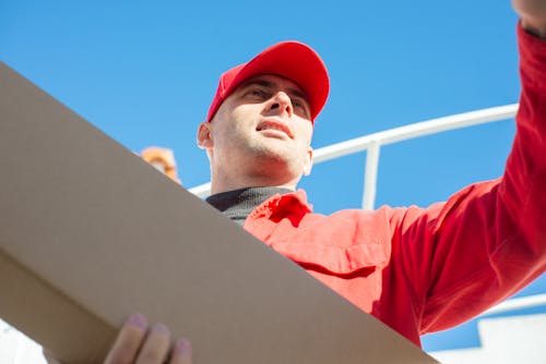 Free Deliveryman Holding a Carton Box Stock Photo