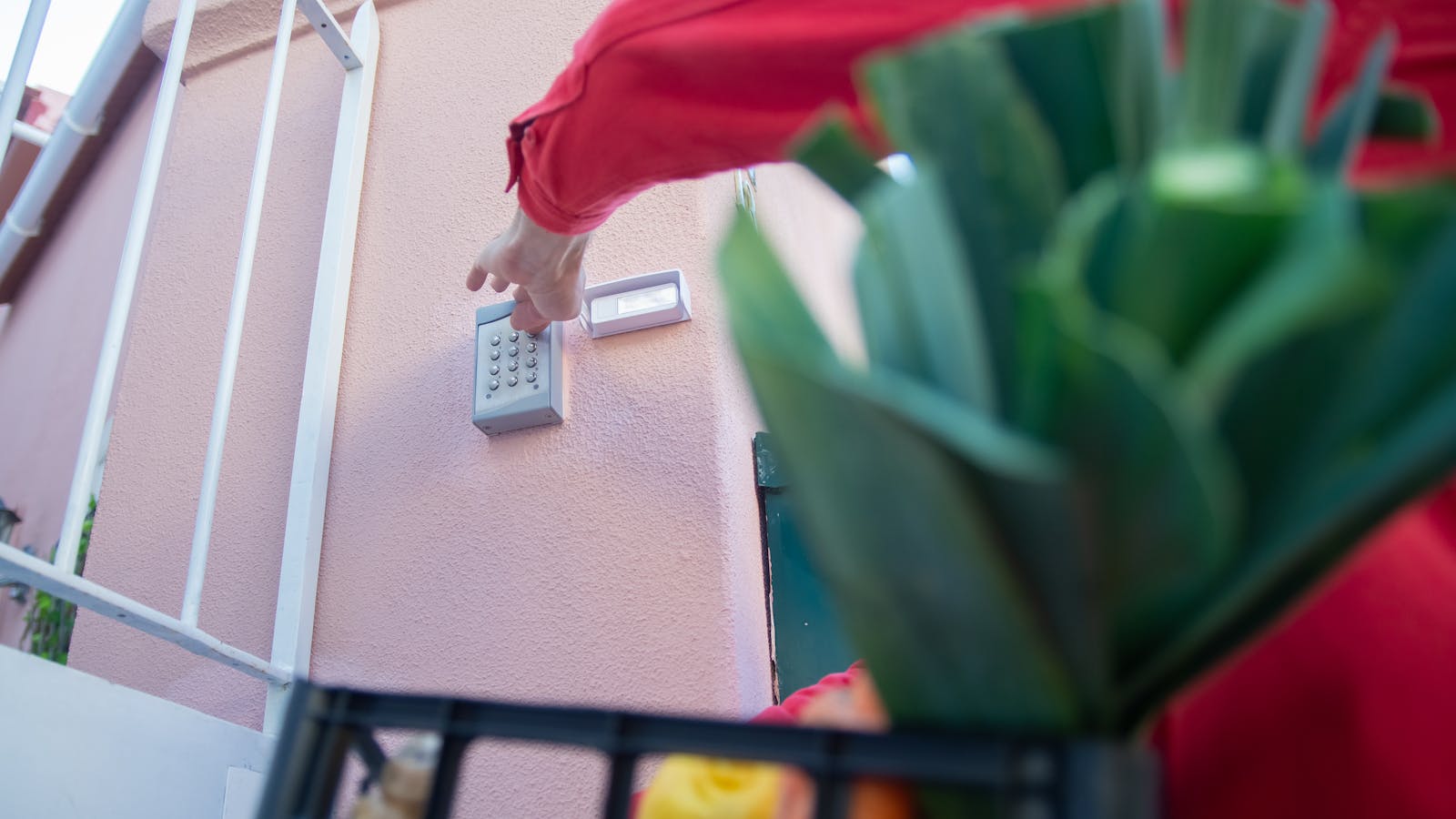 Person installing door security reinforcement hardware with tools and screws