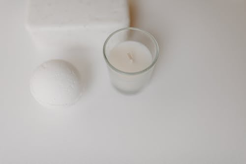 

A Close-Up Shot of a Bath Bomb and a Candle