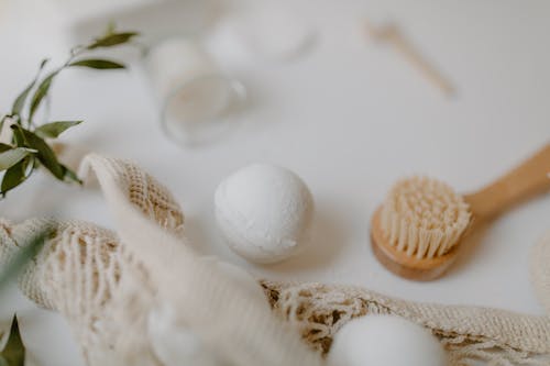 
A Close-Up Shot of a Bath Bomb and a Brush