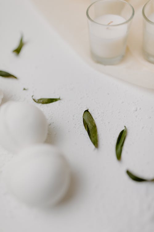 Free 
Green Leaves beside Bath Bombs and Candles Stock Photo