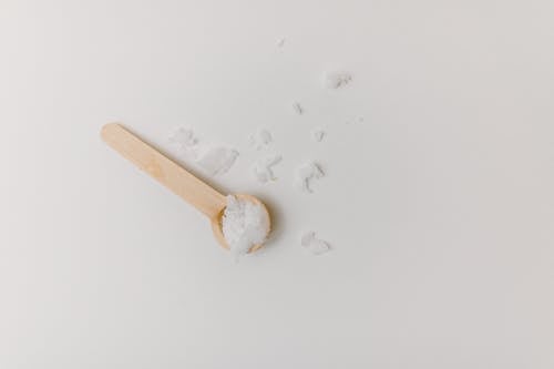 Free Scoop of Bath Salt in Wooden Spoon Photo Stock Photo