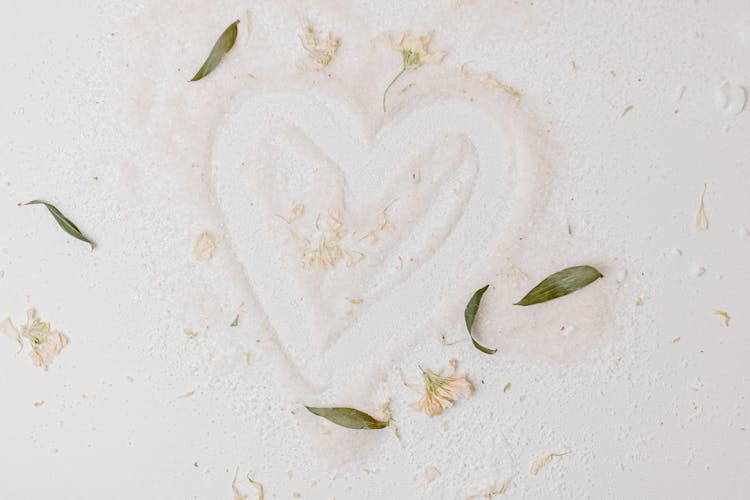 A Heart Shape Design On White Sand Photo