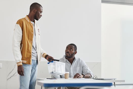 Teacher and student discuss classroom material, exchanging ideas indoors.