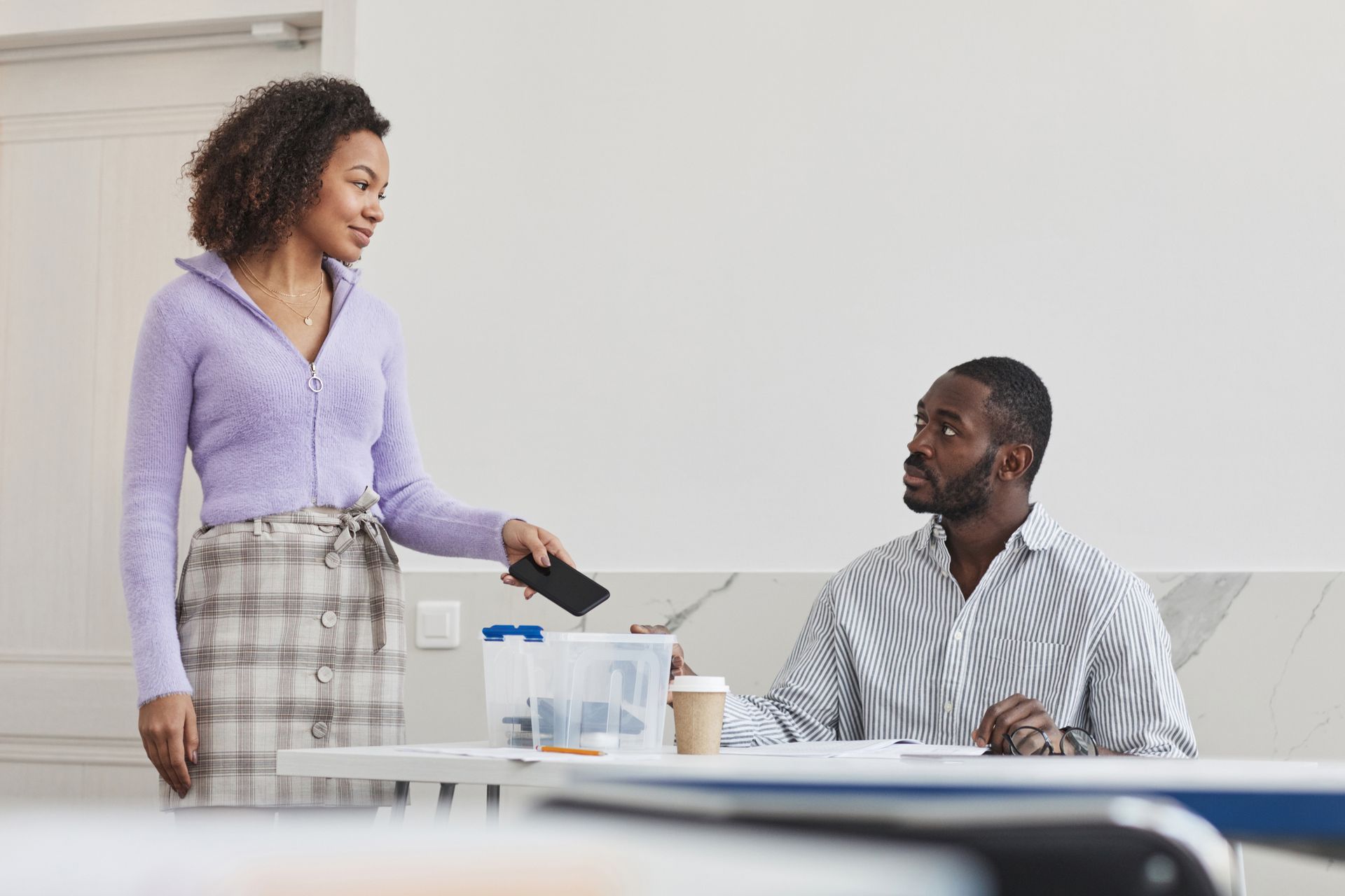 A Woman Giving Her Mobile Phone to His Teacher