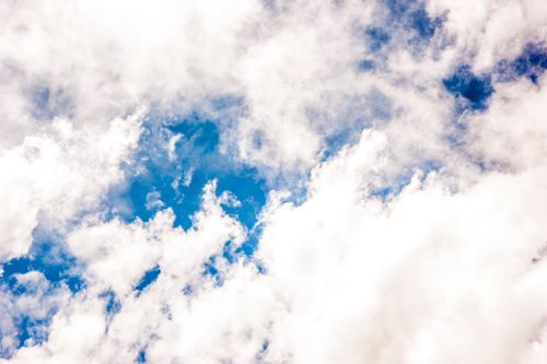 Free Bright blue sky filled with fluffy white clouds on a clear sunny day. Stock Photo