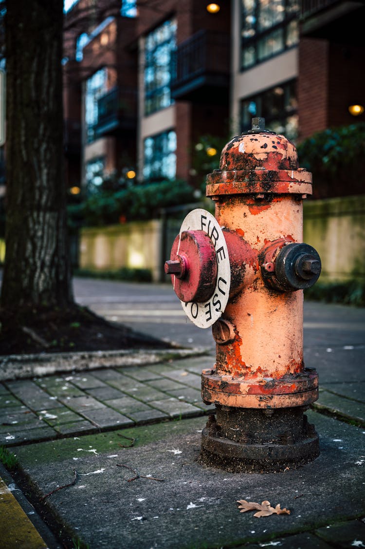 Rusty Weathered Fire Hydrant On City Street