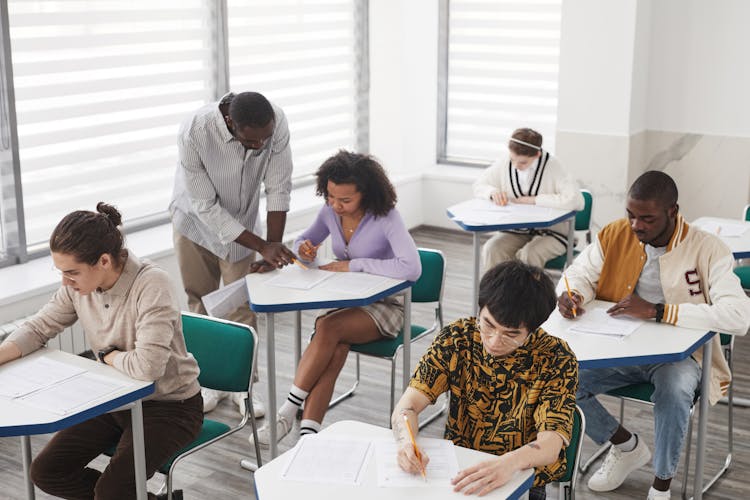 A High Angle Shot Of Students Taking Exam Inside The Classroom