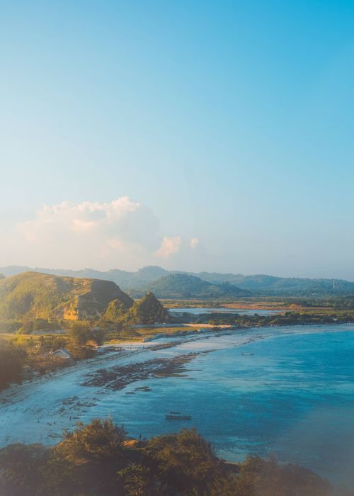 Free A breathtaking view of a coastal landscape with hills and a serene ocean. Stock Photo