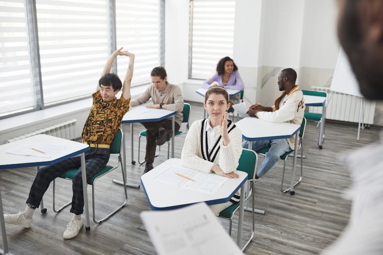 Students Sitting Inside The Classroom