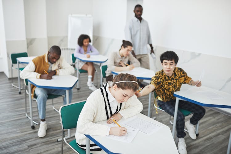 Students Taking Exam Inside The Classroom