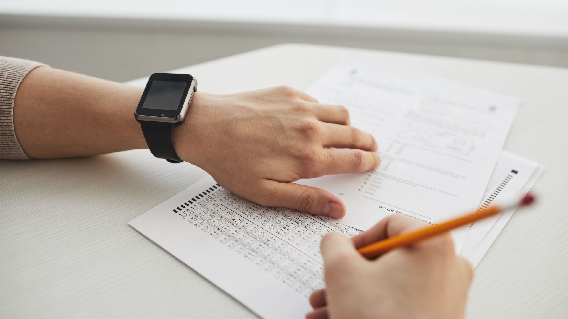 Modafinil for Overnight Exam Cramming: Unlocking Success Student completing a multiple-choice exam with a pencil, close-up view — modafinil for overnight exam cramming