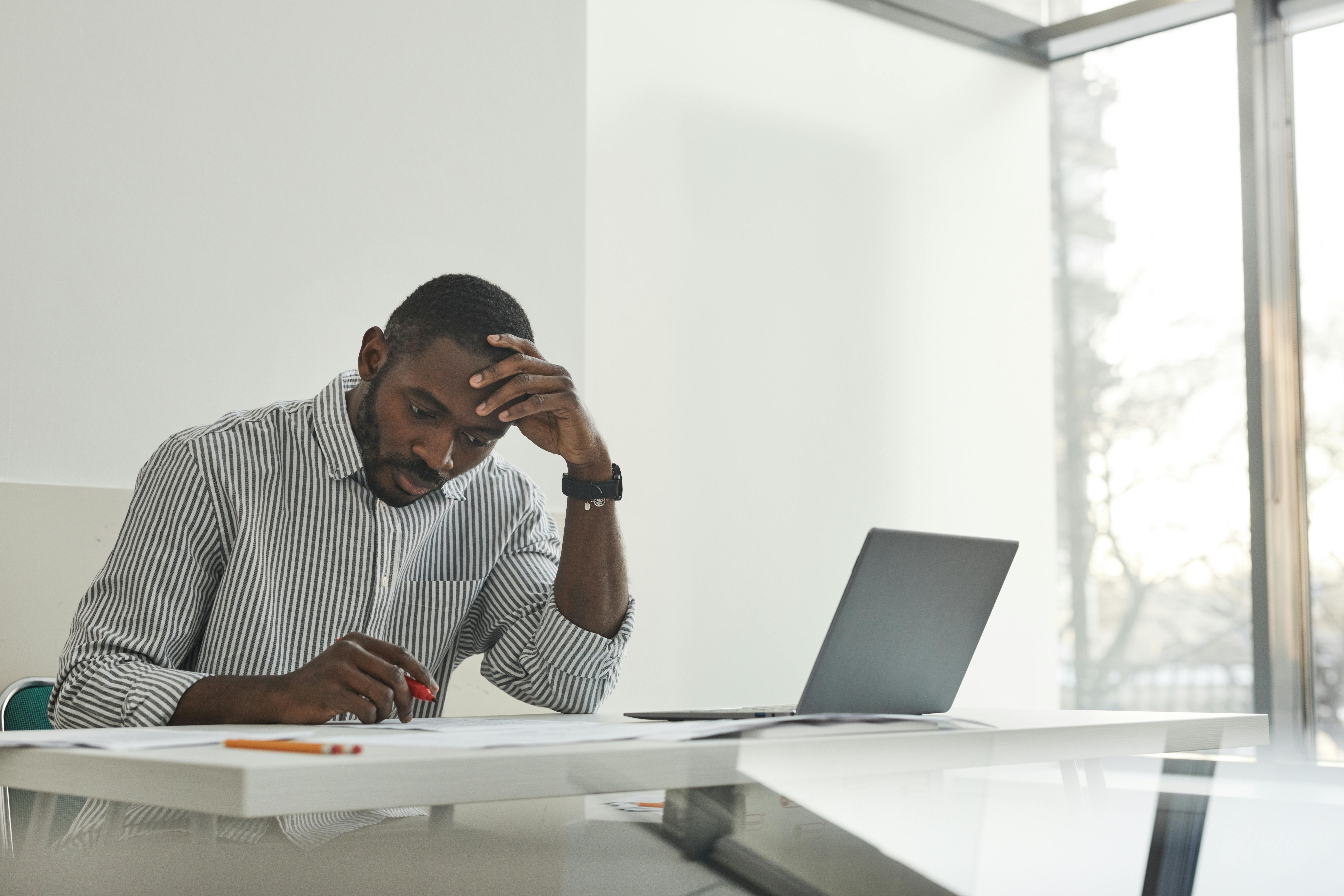A person thoughtfully researching options on a laptop - detox places