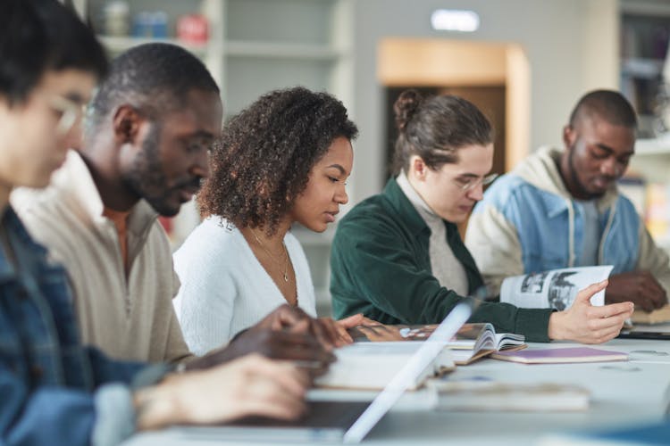 A Group Of Students Studying In The Library