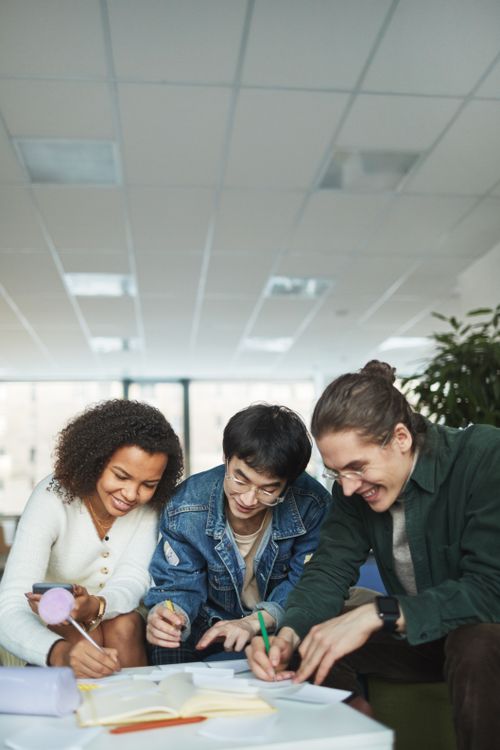 Group of People Writing on a Paper · Free Stock Photo