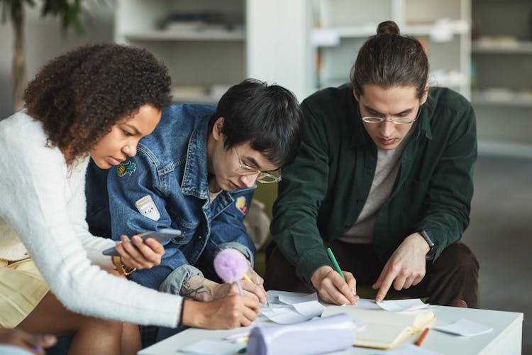 A Group Of Students Studying Together