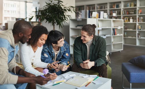 Free Students in a Group Study Inside a Library Stock Photo