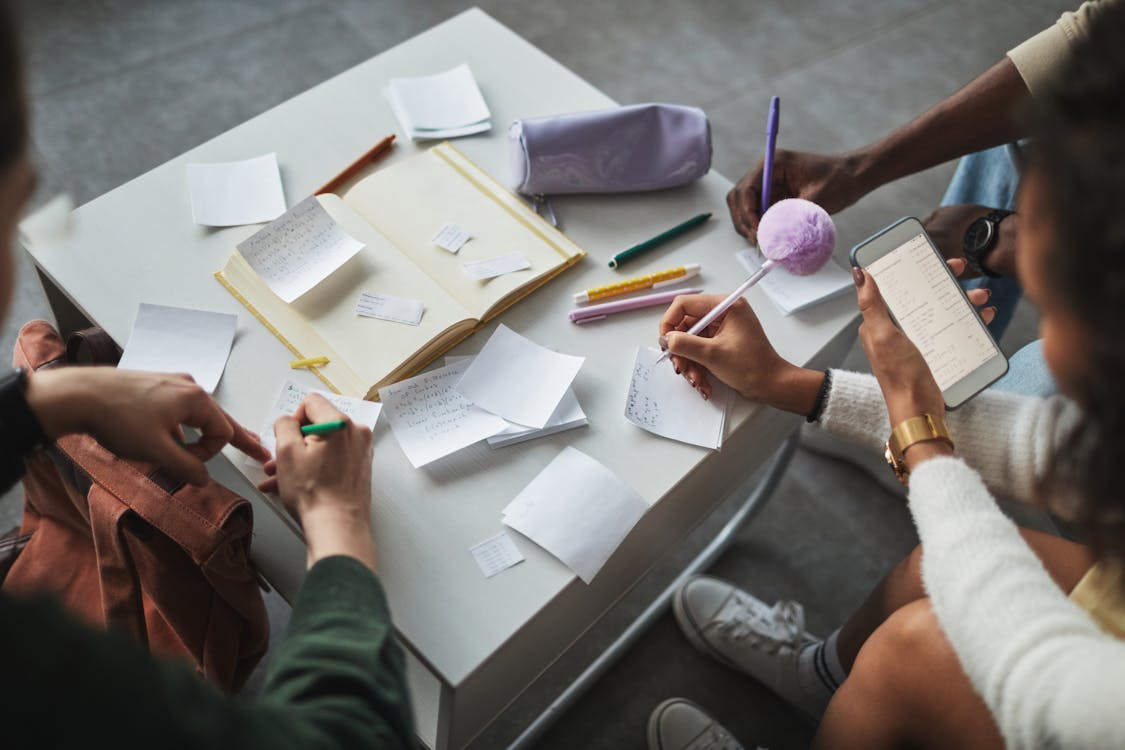 Groups of People Writing Notes on Papers · Free Stock Photo