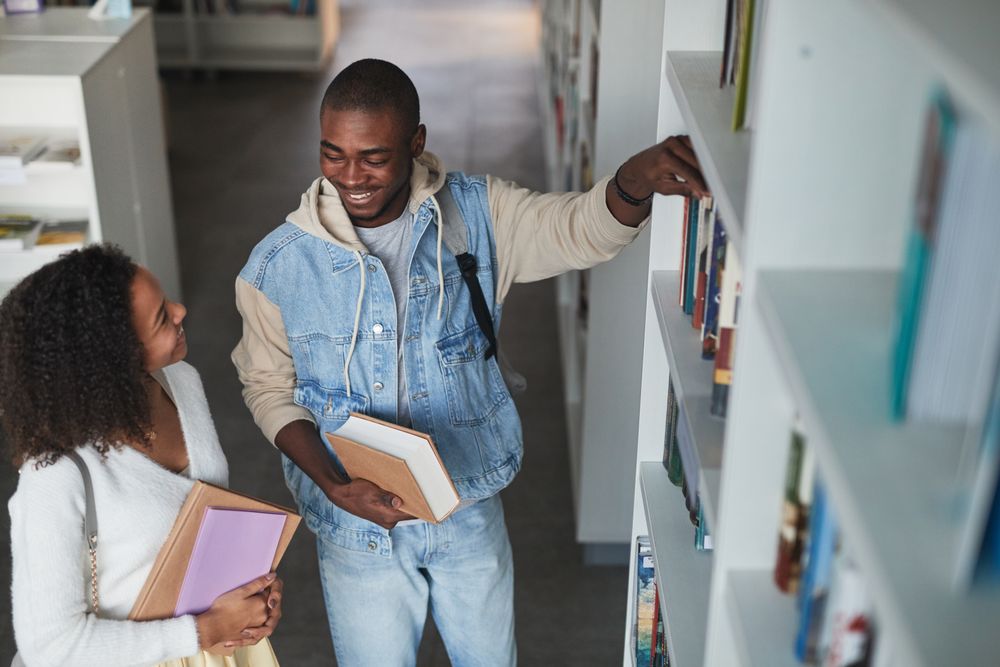 Students selecting books in a library
