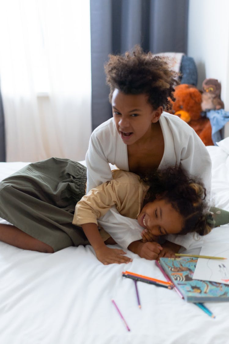 Sibling Playing In The Bed