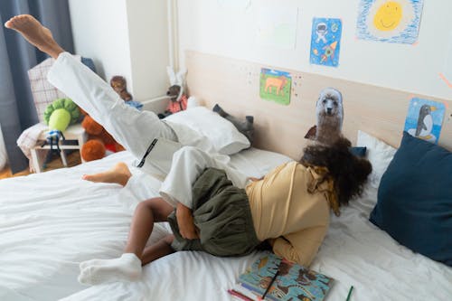 Kids Playing Wrestling in the Bed