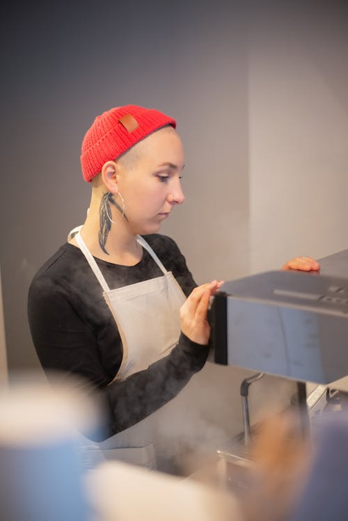 Barista in Red Beanie Working in Cafe