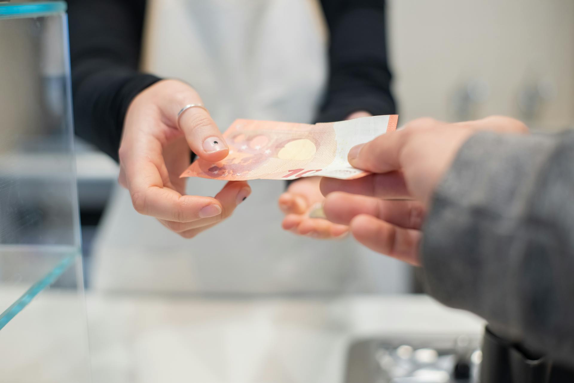 A Customer Paying His Bill with Cash Money