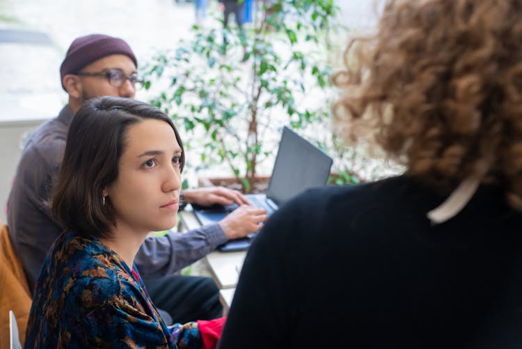 Brunette Woman Looking At Coworker