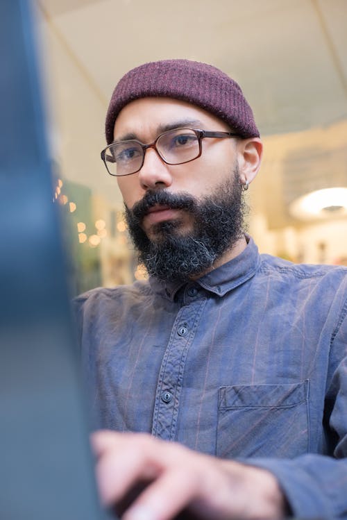 Man in Blue Long Sleeve Shirt Close-Up Photo