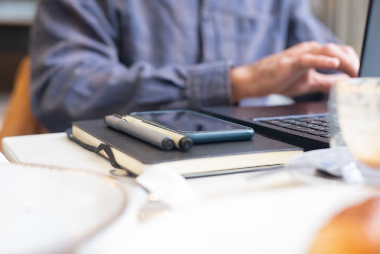 A Person Working With A Laptop