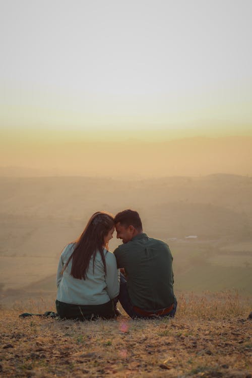 A Couple Sitting on the Ground