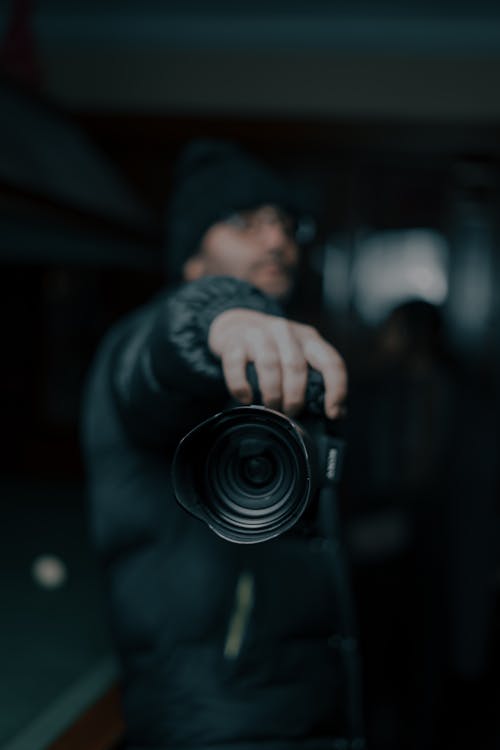 Photographer in outerwear with photo camera