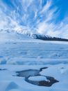 Frozen river near mountainous area