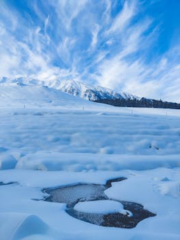 Breathtaking winter scene with a snowy mountain and bright blue sky.