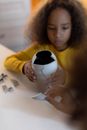 A Young Girl Holding a Broken Vase