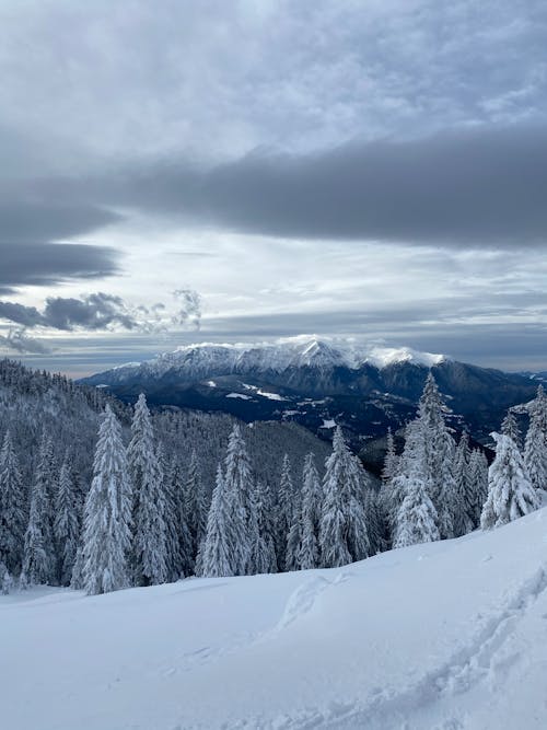 Free Snow Covered Mountain Under White Clouds Stock Photo