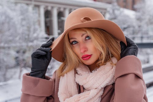 Free A Woman Wearing a Pink Coat and Hat Stock Photo