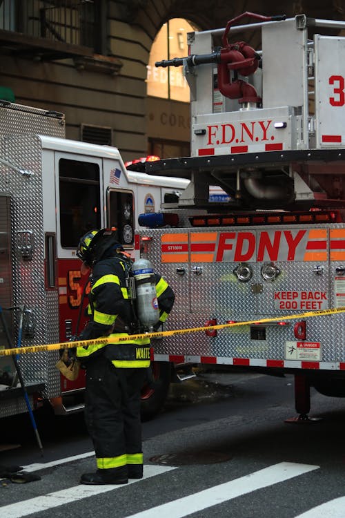 Firefighter in Uniform near Fire Truck