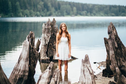 Free Woman Standing on Body of Water Stock Photo