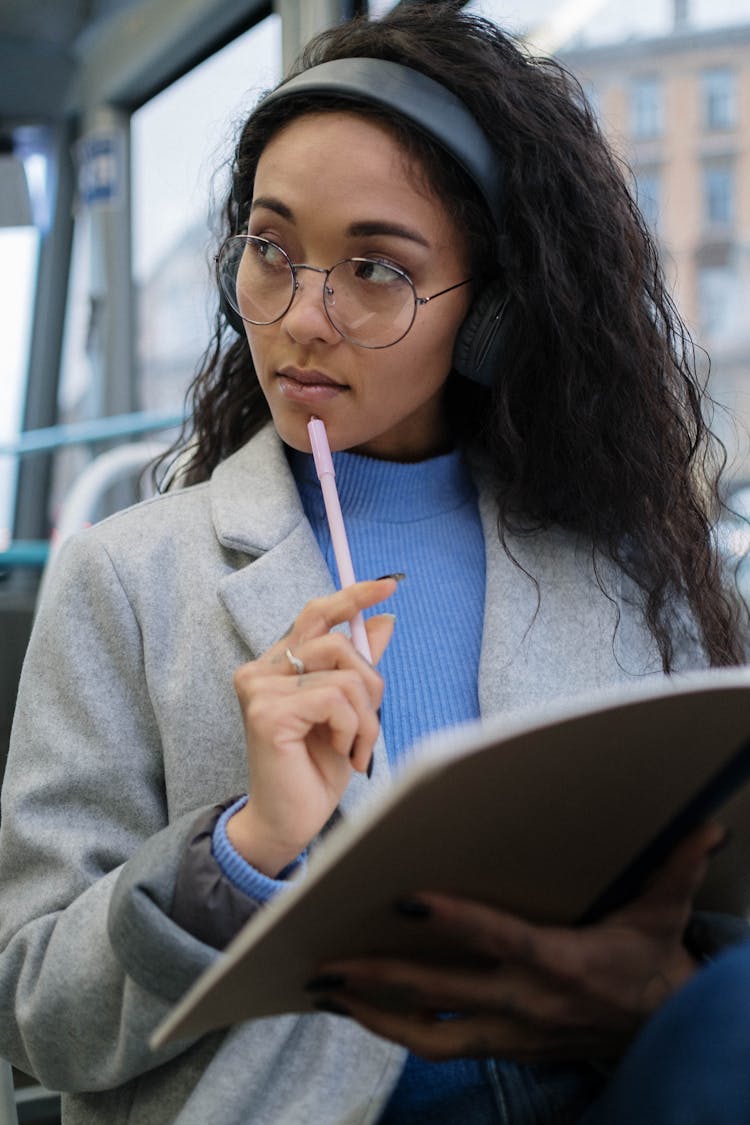 A Woman Holding A Pen While Thinking