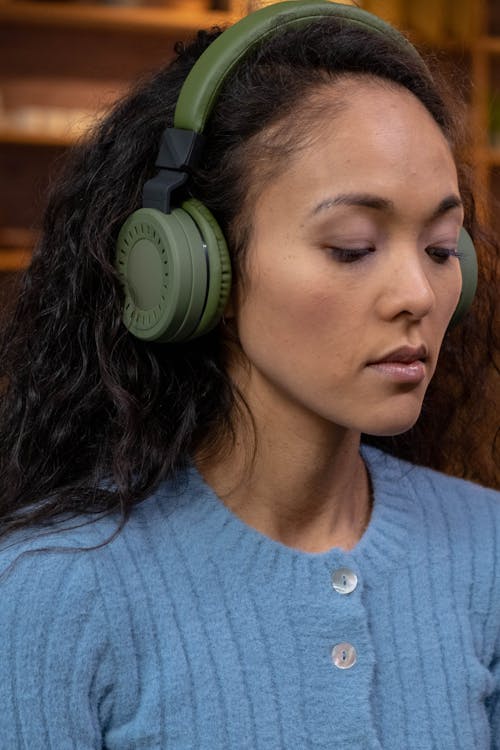 Free Close-Up Shot of a Woman Wearing Green Headphones Stock Photo