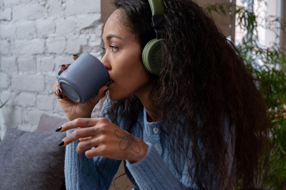 Person listening with coffee