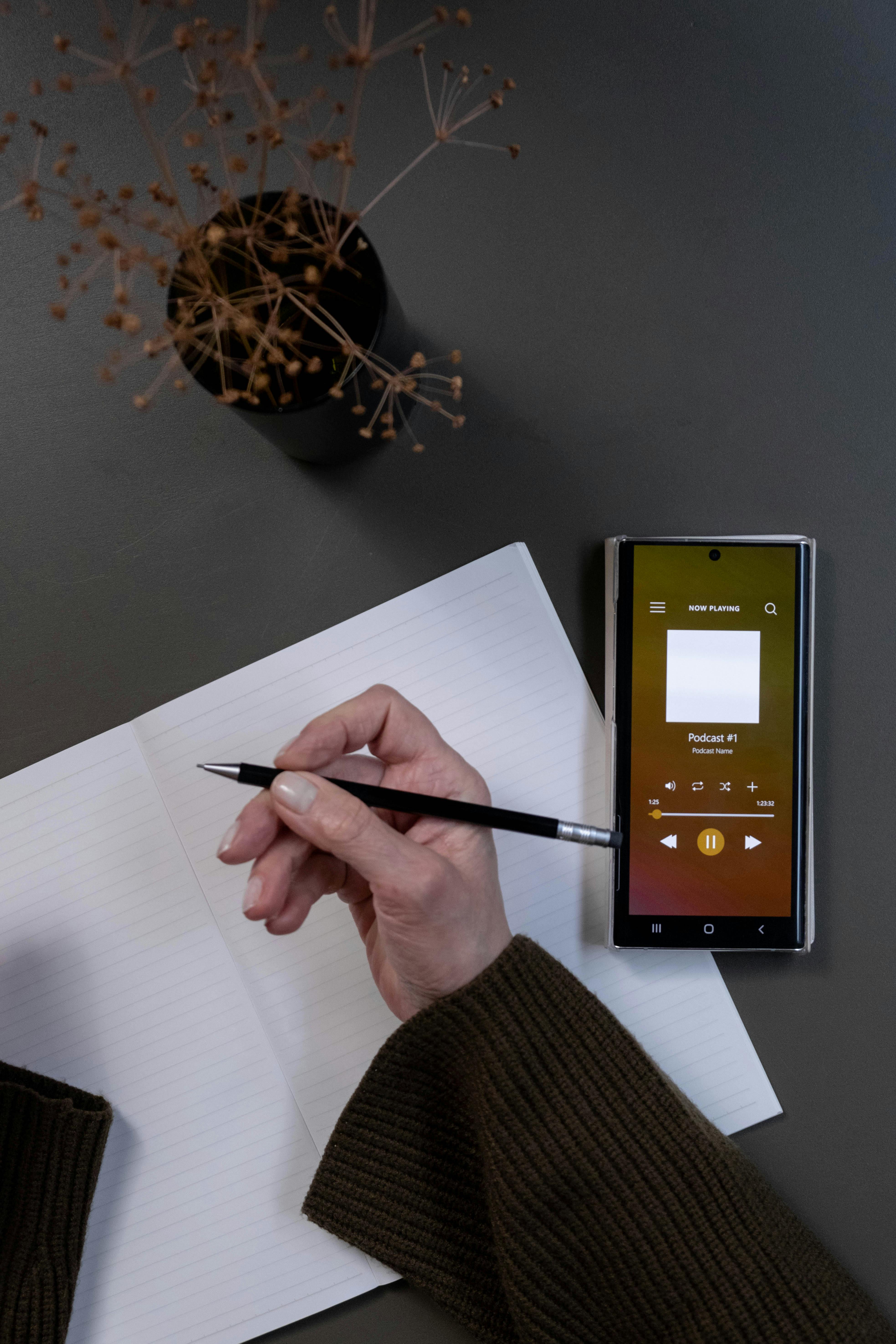 person holding black pen and white paper