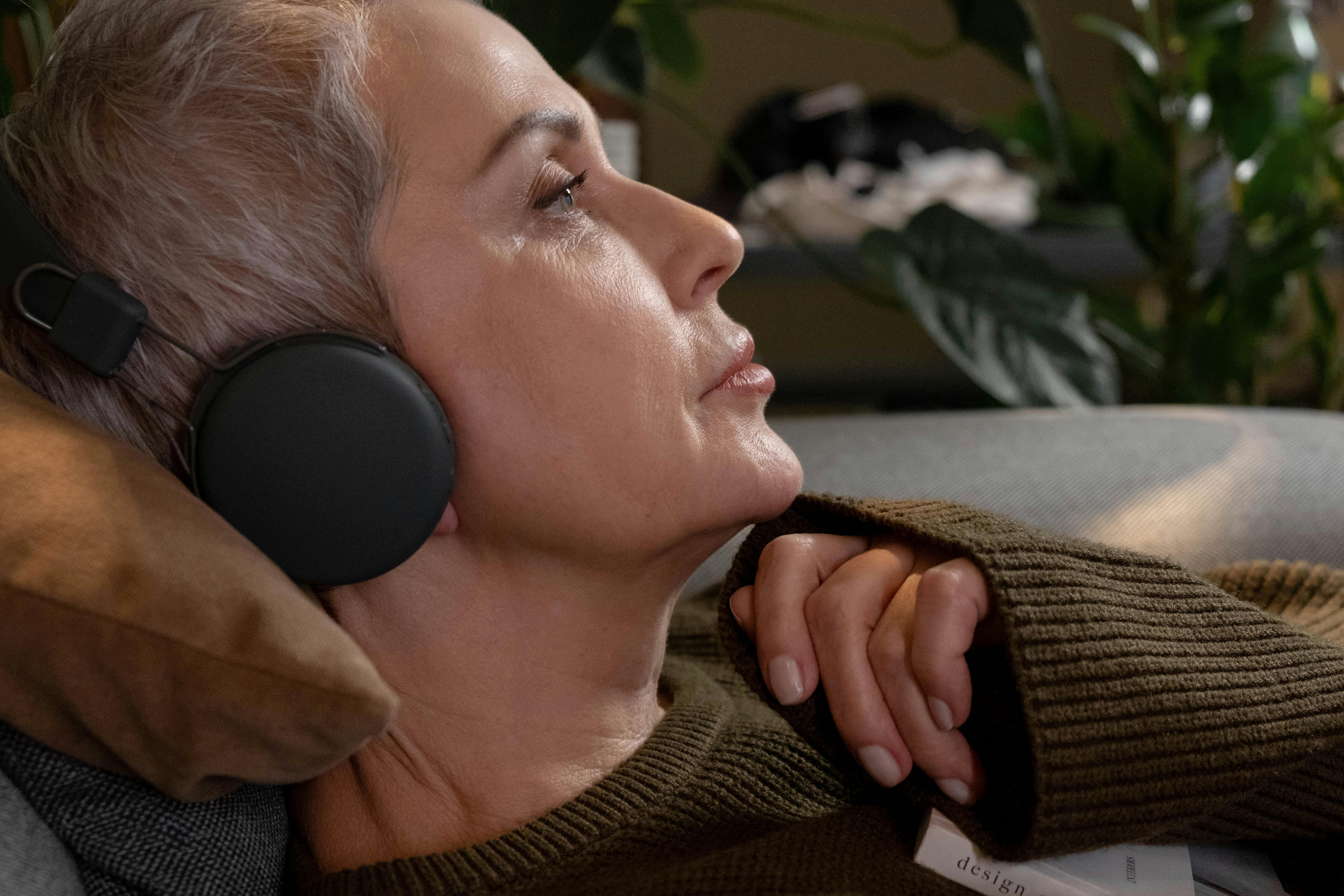 side view of adult woman wearing black headphones