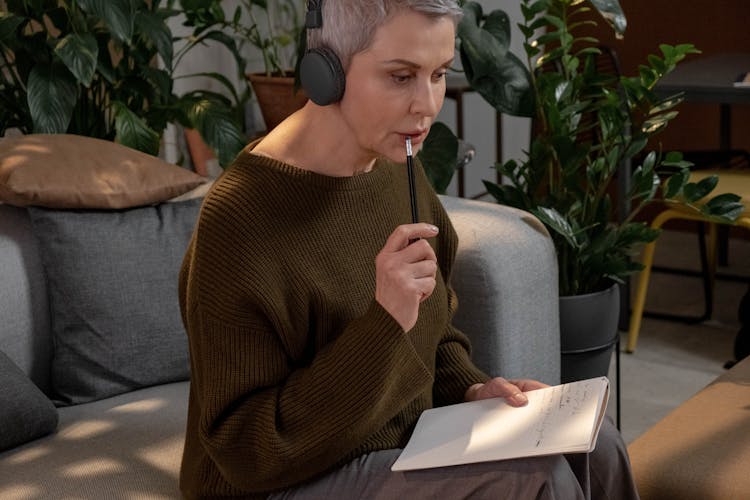 Short Haired Woman Thinking While Holding A Pencil