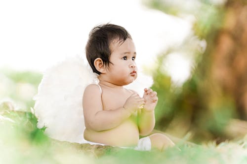 Selective Focus Photo of a Cute Kid with Wings